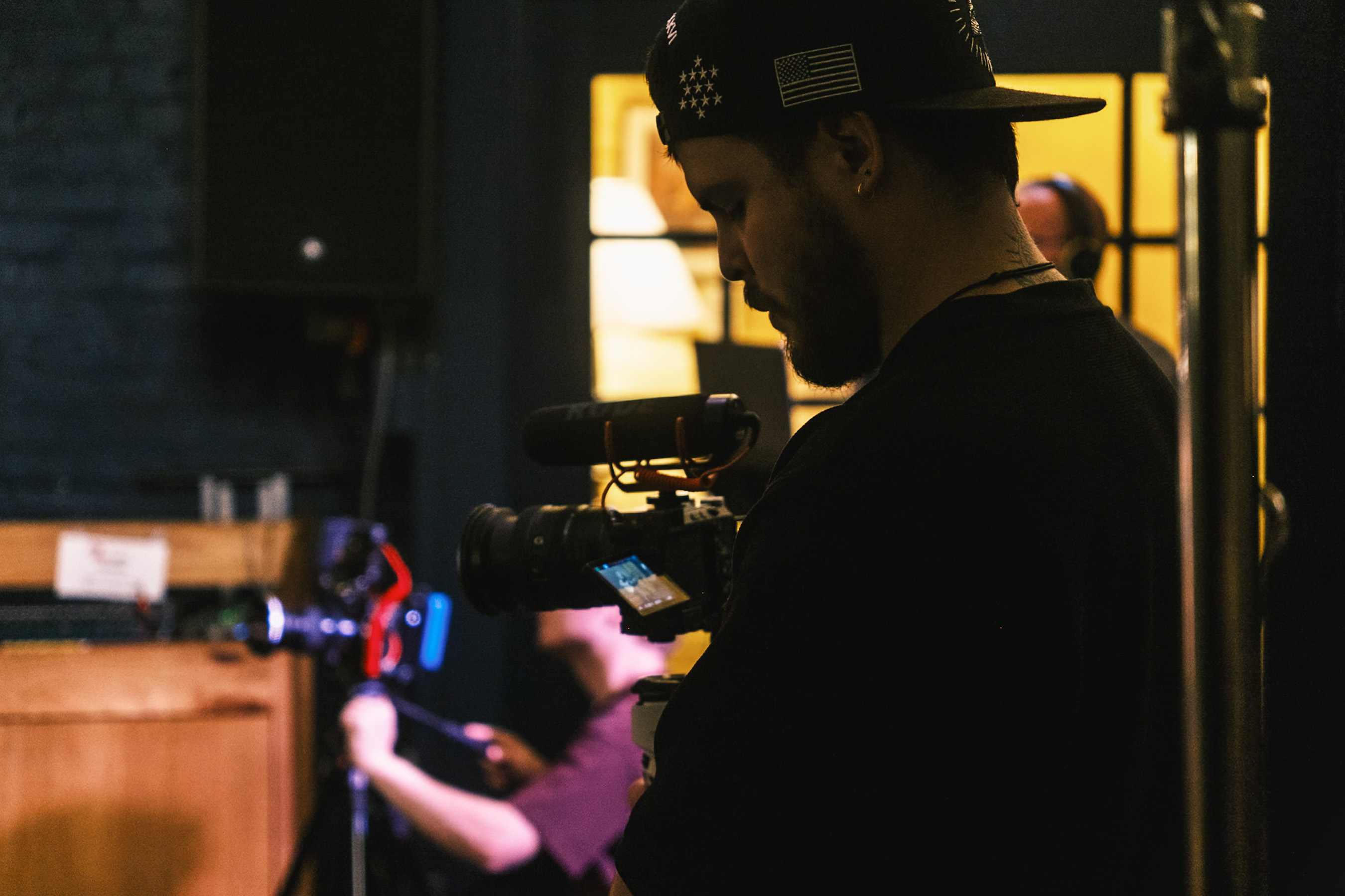 A Stage and Storytelling camera operator filming a live session