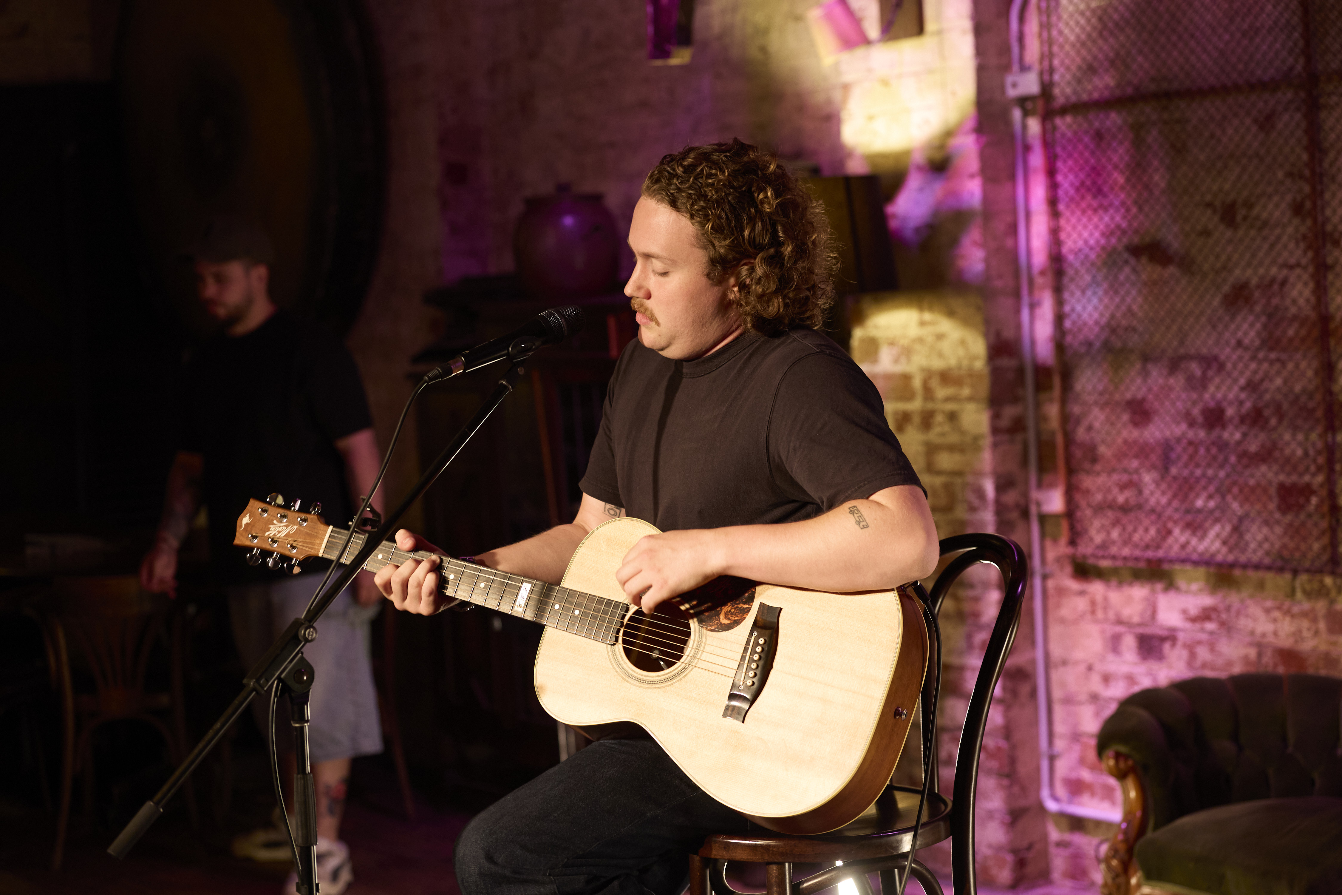 Artist performing live at a Stage and Storytelling showcase